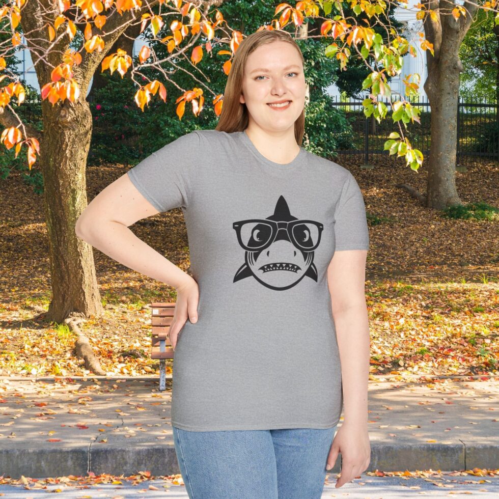 A woman in the park wearing a grey shark shirt