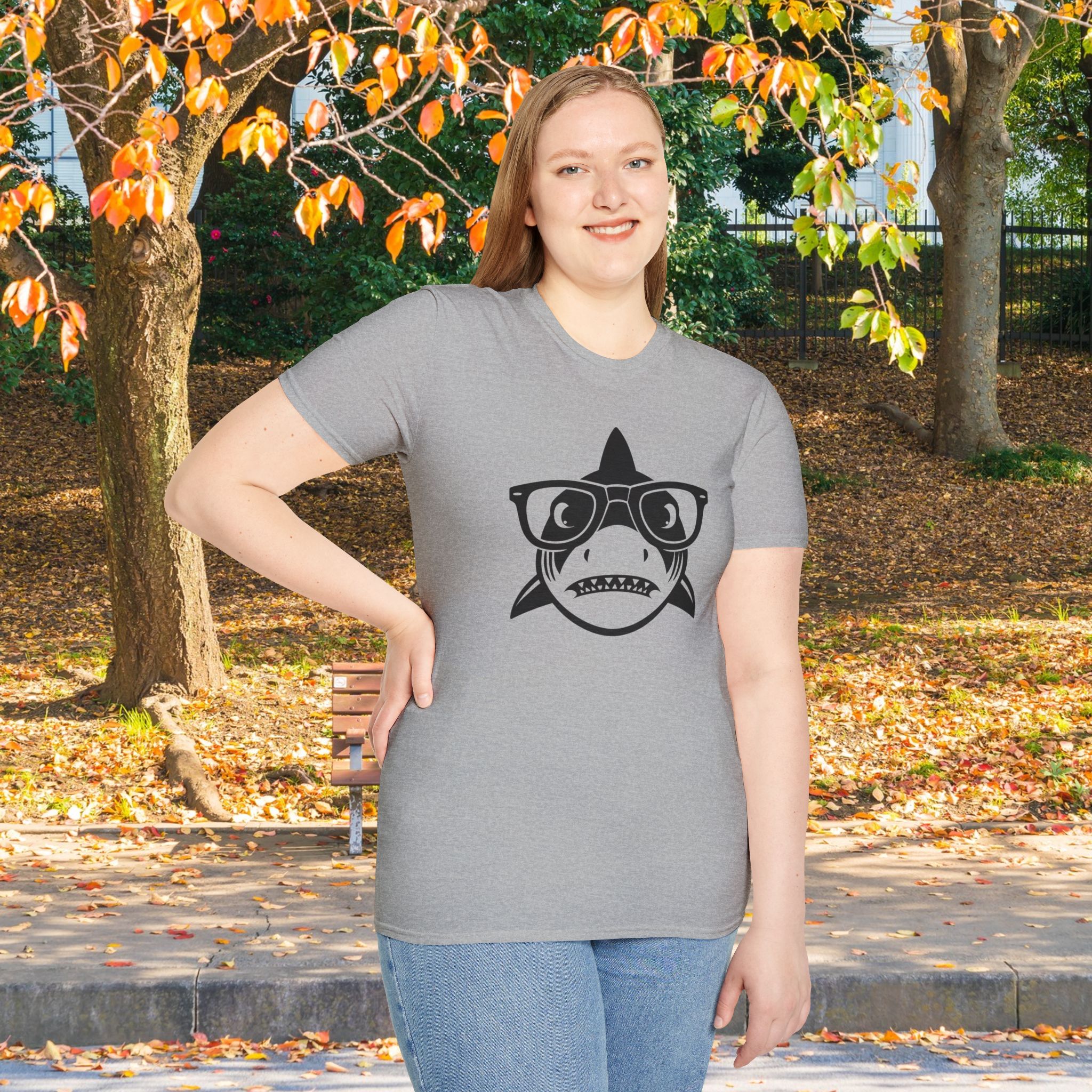 A woman in the park wearing a grey shark shirt